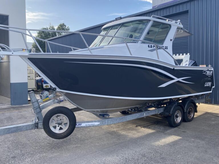 Boat Parked in Front of A Building by The Water's Edge — Secondhand Boat Motors in Hervey Bay